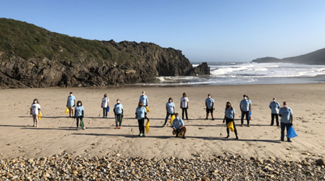 Voluntarios, clientes y colaboradores limpian de residuos la costa asturiana de San Antolín
